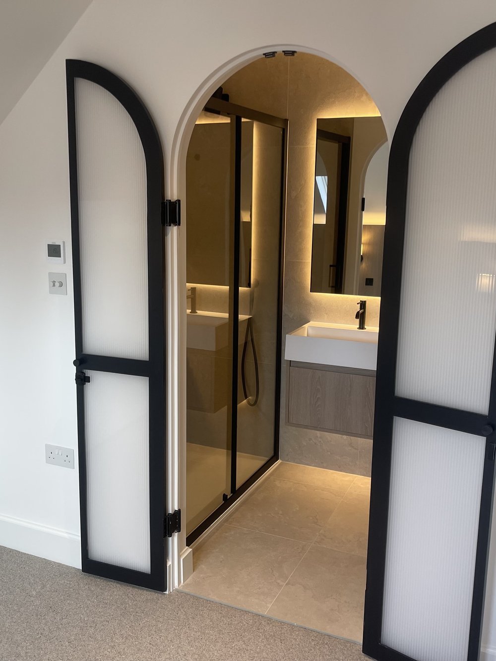 Arched doors to a loft en suite, maisonette refurbishment, Poole