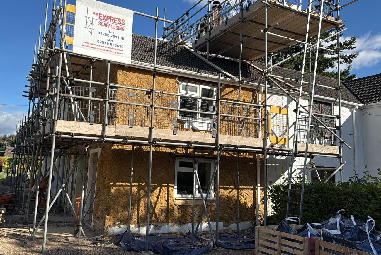 Cob cottage under scaffold